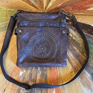 Patricia Nash Brown Leather Crossbody Bag with studded decal pattern.
